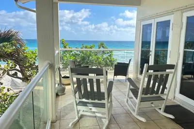 a balcony with chairs and a view of the ocean at Gorgeous 4-bedroom beach space in Hollywood