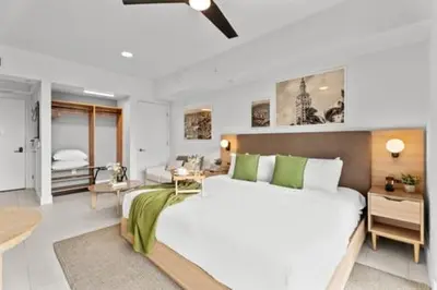 a bedroom with a large bed and a living room at Suite at downtown Miami residences - Great view 30th floor in Miami
