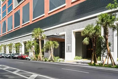 a building with palm trees in front of a street at Suite at downtown Miami residences - Great view 30th floor in Miami