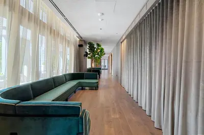 a waiting room with green couches and curtains at Suite at downtown Miami residences - Great view 30th floor in Miami