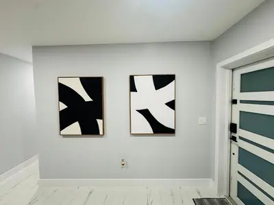 three black and white paintings on a white wall at 5 Bedroom Home Location & Charm in Miami