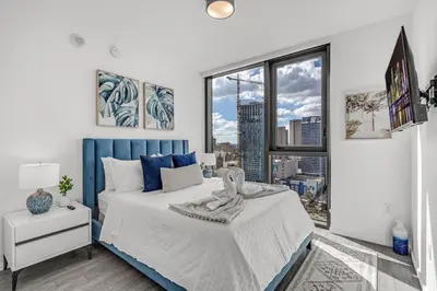a bedroom with a large bed and a large window at Experience Miami Modern 2 Bed Near Biscayne Blvd in Miami