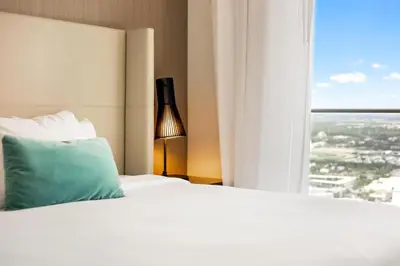 a bed with a green pillow and a window at 42nd Floor Penthouse 3 BDR in Hyde Beach House in Hollywood