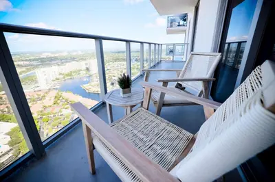 a balcony with two chairs and a view of the city at 42nd Floor Penthouse 3 BDR in Hyde Beach House in Hollywood