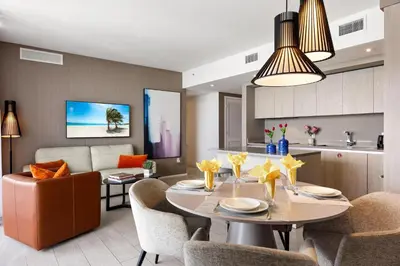 a dining room and living room with a table and chairs at 42nd Floor Penthouse 3 BDR in Hyde Beach House in Hollywood