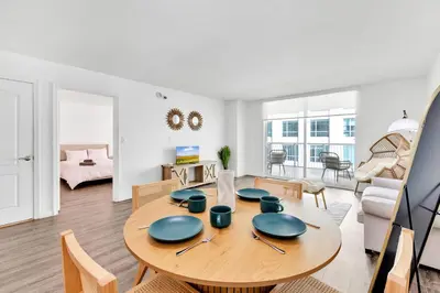 a dining room and living room with a wooden table at Luxury Miami Brickell Stay-Bay View in Miami