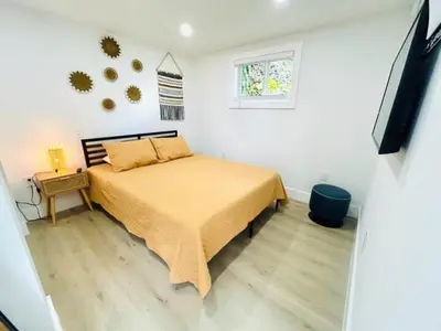 a bedroom with a bed with a yellow bedspread at Chic Comfortable Boutique Stay in Miami