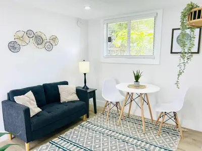 a living room with a blue couch and a table at Chic Comfortable Boutique Stay in Miami