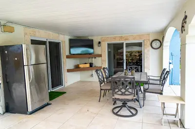 a dining room with a table and a refrigerator at The Aqua Villa in Hollywood