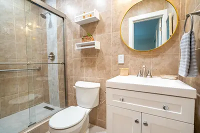 a bathroom with a toilet and a sink and a shower at The Aqua Villa in Hollywood