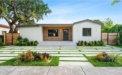 a home with a stone pathway in front of a house at Miami Oasis by Brickell and Beaches in Miami