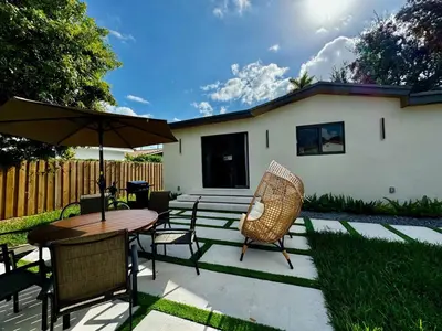 a patio with a table and chairs and an umbrella at Miami Oasis by Brickell and Beaches in Miami
