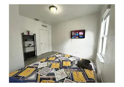 a bedroom with a bed with a colorful quilt at 2bed Stay in the Heart of Miami in Miami