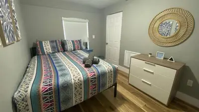 a bedroom with a bed and a dresser and a mirror at 1Bed Abode Near Main Attractions in Miami