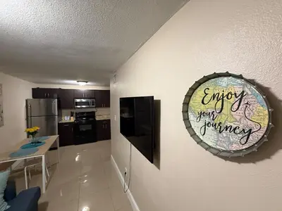 a kitchen with a sign that says enjoy your journey at 1Bed Abode Near Main Attractions in Miami