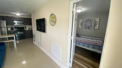 a hallway leading to a kitchen and a living room at 1Bed Abode Near Main Attractions in Miami