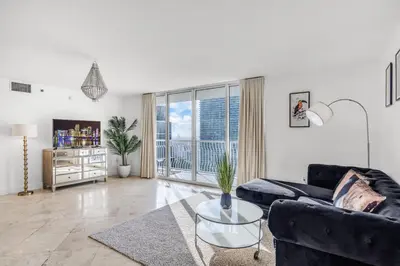 a living room with a couch and a table at Best views, 2 balconies, 2 bedrooms, pool, gym, parking in Miami