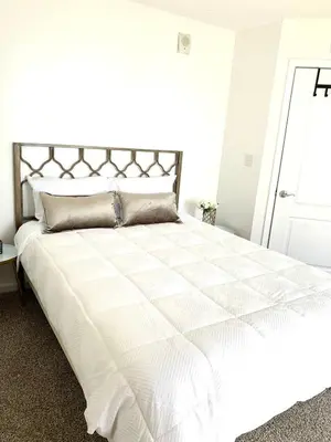 a bedroom with a white bed with a white comforter at Best views, 2 balconies, 2 bedrooms, pool, gym, parking in Miami