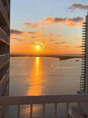 a sunset from the balcony of a cruise ship at Best views, 2 balconies, 2 bedrooms, pool, gym, parking in Miami