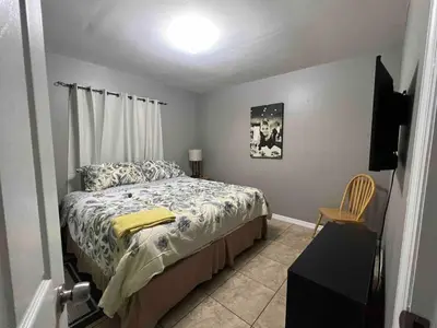 a bedroom with a bed and a television in it at Known for its beaches & walk to downtown Hollywood Bliss 3 in Hollywood