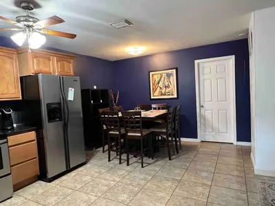 a kitchen with a table with chairs and a refrigerator at Known for its beaches & walk to downtown Hollywood Bliss 3 in Hollywood