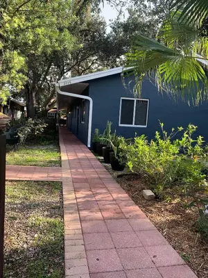 a blue building with a sidewalk in front of it at Known for its beaches & walk to downtown Hollywood Bliss 3 in Hollywood