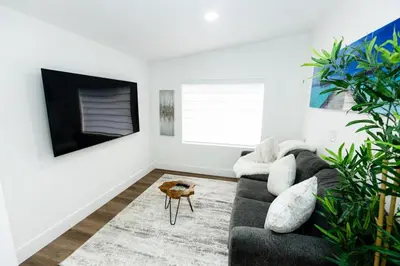 a living room with a couch and a tv at Your Perfect Oasis in Miami! in Miami