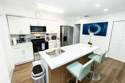 a kitchen with white cabinets and a white counter top at Your Perfect Oasis in Miami! in Miami