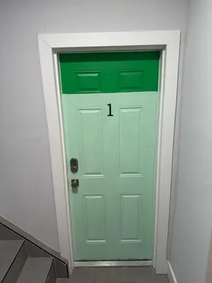 a green door with the number on it at Prime Location Near Wynwood in Miami