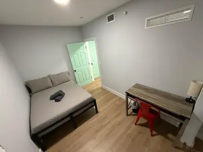 a room with a bed and a bench and a door at Perfect Central Stay in Miami