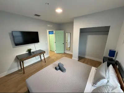 a bedroom with a bed and a flat screen tv at Stay Near Wynwood in Miami