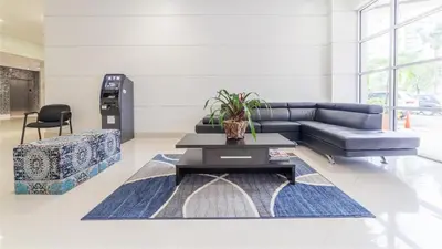 a living room with a couch and a table at Beachfront Oasis in Sunny Isles 3BR, Pool & Tennis in Sunny Isles Beach