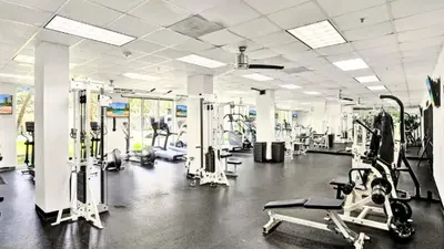 a gym with several treadmills and machines in it at Beachfront Oasis in Sunny Isles 3BR, Pool & Tennis in Sunny Isles Beach