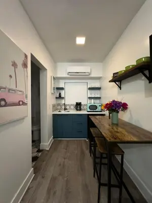 a kitchen with a wooden table in a room at Hotel Rainbow - Miami - Little Havanna in Miami