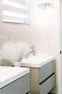 a bathroom with white counters and a sink at Welcome to 305 Rentals in Miami Gardens
