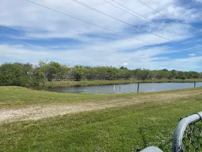 a large body of water with trees in the background at Gardens Get Away in Pembroke Pines