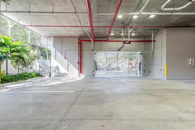 an empty parking lot with a gate in a parking garage at Resort-Style 1 Bed Condo with Pool Parking Rooftop & Gym in Hollywood