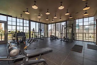 a gym with cardio equipment in a large room with windows at Phenomenal 1 Bed - Amazing views in Miami