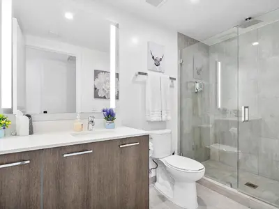 a bathroom with a toilet and a glass shower at X Lounge III-Modern Corner Residence in Miami