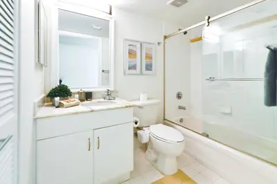 a bathroom with a toilet and a sink and a shower at Condo That Will Make Feel the Ocean Breeze Close in Miami