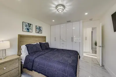 a bedroom with a bed and a walk in closet at Luxurious Tropical Private Oasis by Mia Airport in Hialeah