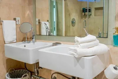 a bathroom with a white sink and a mirror at Stunning Beachfront condo in sunny Sunny Isles Beach with AC, fitness room, WiFi in Sunny Isles Beach