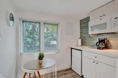 a kitchen with a table and a small table with a chair at Tropical Oasis Studio w Pool in Fort Lauderdale