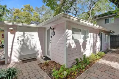 a pink house with a garage at Tropical Oasis Studio w Pool in Fort Lauderdale