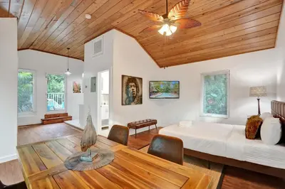 a living room with a bed and a table at Tropical Oasis Studio w Pool in Fort Lauderdale