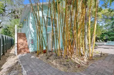 a house with a group of trees in front of it at Tropical Oasis Studio w Pool in Fort Lauderdale