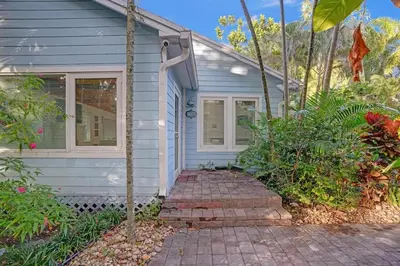 a house with a brick walkway leading to the front door at Tropical Oasis 2BR House w Pool in Fort Lauderdale
