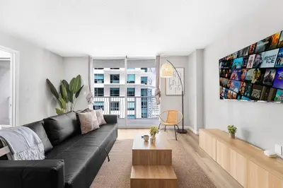 a living room with a black leather couch at Enjoy of Beautiful City Views From This Condo in Miami