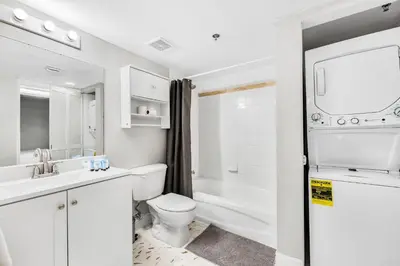 a white bathroom with a toilet and a sink at Enjoy of Beautiful City Views From This Condo in Miami