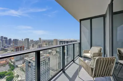 a balcony with chairs and a view of the city at On 47th Floor! Free Parking & Views From The Top in Miami